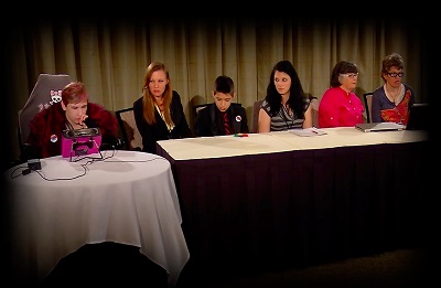 Children on a speaker panel at a conference